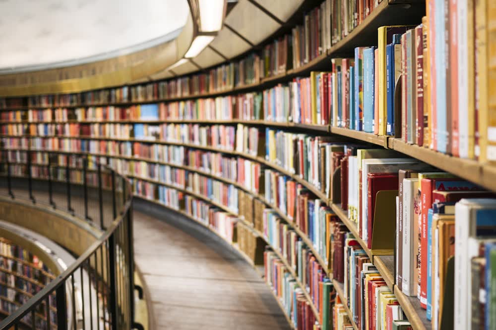 Curved shelves of a library full of books